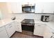 Modern kitchen with stainless steel appliances and white shaker cabinets at 3630 N Davidson St, Charlotte, NC 28205