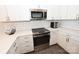 Modern kitchen with stainless steel appliances and white shaker cabinets at 3630 N Davidson St, Charlotte, NC 28205