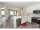 Open concept kitchen featuring island, stainless steel appliances, and white cabinetry at 3630 N Davidson St, Charlotte, NC 28205