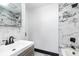 Modern bathroom with marble tile, updated vanity, and bathtub at 412 N Vance St, Gastonia, NC 28052