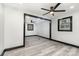 Bedroom with gray floors, white walls, and ceiling fan at 412 N Vance St, Gastonia, NC 28052