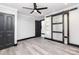 Bedroom with barn door to bathroom, ceiling fan and hardwood floors at 412 N Vance St, Gastonia, NC 28052