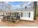 White house with black accents, covered porch, and landscaping at 412 N Vance St, Gastonia, NC 28052