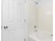 Simple bathroom with a tub and shower, and white tile at 4321 Bobterry Ct, Charlotte, NC 28216