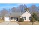 Beige house with gray roof, black shutters, and a driveway at 4321 Bobterry Ct, Charlotte, NC 28216