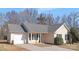 Tan house with a gray roof and a white garage door at 4321 Bobterry Ct, Charlotte, NC 28216