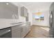 Bright kitchen features gray cabinets, quartz countertops, stainless steel dishwasher, and natural light at 4321 Bobterry Ct, Charlotte, NC 28216