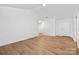 Light-filled living room with wood-look flooring, white walls, recessed lighting, and a white entry door at 4321 Bobterry Ct, Charlotte, NC 28216