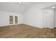 Living room with hardwood floors and French doors leading to the backyard at 4321 Bobterry Ct, Charlotte, NC 28216