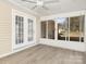 Relaxing sunroom featuring vinyl flooring, ceiling fan, and sliding windows with backyard view at 4321 Bobterry Ct, Charlotte, NC 28216