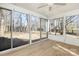 Relaxing sunroom featuring vinyl flooring, ceiling fan, and sliding windows with backyard view at 4321 Bobterry Ct, Charlotte, NC 28216