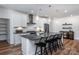 Modern kitchen with white cabinets, dark countertop island, and stainless steel appliances at 4784 Formation Ct # 066, Lancaster, SC 29720