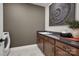 Laundry room with gray walls, dark brown cabinets, and quartz countertops at 4803 Formation Ct # 104, Lancaster, SC 29720