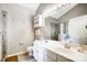 A full bathroom with a double sink vanity, a shower, and a water closet at 4918 Sunset Ridge Ct, Charlotte, NC 28269