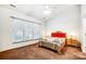 A carpeted bedroom with large windows providing natural light at 4918 Sunset Ridge Ct, Charlotte, NC 28269