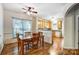 Dining area featuring hardwood floors, ceiling fan, and lots of natural light at 4918 Sunset Ridge Ct, Charlotte, NC 28269