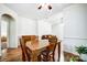 A dining room featuring wood floors, a ceiling fan, and a wooden table at 4918 Sunset Ridge Ct, Charlotte, NC 28269