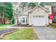 Inviting home featuring a one car garage, tidy landscape, and well-kept lawn at 4918 Sunset Ridge Ct, Charlotte, NC 28269