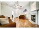 Cozy living room with fireplace, hardwood floors, and lots of natural light at 4918 Sunset Ridge Ct, Charlotte, NC 28269