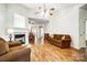 Cozy living room features hardwood floors, ceiling fan, and neutral colors at 4918 Sunset Ridge Ct, Charlotte, NC 28269