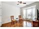 A sitting room featuring wood floors, a ceiling fan, and natural light at 4918 Sunset Ridge Ct, Charlotte, NC 28269