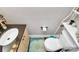 Compact powder room featuring a toilet and floating vanity with sink at 4923 Park Rd # D, Charlotte, NC 28209