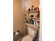 Small bathroom with toilet and a white shelving unit at 4923 Park Rd # D, Charlotte, NC 28209