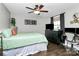 Cozy bedroom features a ceiling fan and dark wooden floors at 4923 Park Rd # D, Charlotte, NC 28209