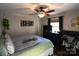 Spacious bedroom with a large bed, home office space, and ceiling fan at 4923 Park Rd # D, Charlotte, NC 28209