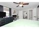 Well-lit bedroom featuring a ceiling fan, desk, and ensuite bath at 4923 Park Rd # D, Charlotte, NC 28209