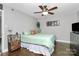 Cozy bedroom with ceiling fan, warm wood floors, and comforting decor at 4923 Park Rd # D, Charlotte, NC 28209