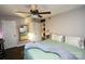 Main bedroom with king-size bed, en-suite bathroom access, and a ceiling fan at 4923 Park Rd # D, Charlotte, NC 28209