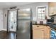 Open kitchen area featuring stainless steel refrigerator, black countertops and door to the backyard at 4923 Park Rd # D, Charlotte, NC 28209