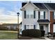 Two-story townhome with gray siding, dark trim, and landscaping at 4968 Sunburst Ln, Charlotte, NC 28213