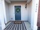 Inviting front door entrance with a stylish wreath and striped welcome mat at 4968 Sunburst Ln, Charlotte, NC 28213