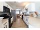 Modern kitchen with white cabinetry, stainless steel appliances, and hardwood floors at 4968 Sunburst Ln, Charlotte, NC 28213