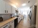 Modern kitchen with white cabinets, stainless steel appliances, and light countertops at 4968 Sunburst Ln, Charlotte, NC 28213