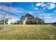 Two-story house with a green lawn and partial view of the neighborhood at 501 Alucio Ct, Matthews, NC 28104