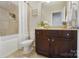 Clean bathroom with dark brown vanity, tile shower, and a toilet at 501 Alucio Ct, Matthews, NC 28104