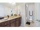 Modern bathroom with dark brown vanity, granite countertop, and a mirror at 501 Alucio Ct, Matthews, NC 28104