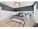 Serene bedroom with dark blue walls, white wainscoting, and ceiling fan at 501 Alucio Ct, Matthews, NC 28104