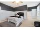 Spacious bedroom with dark gray and white walls, comfortable bedding, and a ceiling fan at 501 Alucio Ct, Matthews, NC 28104