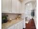 Butlers pantry with granite countertops and white cabinets at 501 Alucio Ct, Matthews, NC 28104