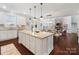 Island kitchen with white cabinets, granite countertops, and stainless steel appliances at 501 Alucio Ct, Matthews, NC 28104