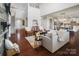 Two-story living room with hardwood floors, stone fireplace, and an open floor plan at 501 Alucio Ct, Matthews, NC 28104