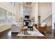 Bright living room featuring built-in shelving, a cozy fireplace, and large windows offering ample natural light at 501 Alucio Ct, Matthews, NC 28104