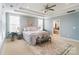 Spacious main bedroom with light blue walls and ceiling fan at 501 Alucio Ct, Matthews, NC 28104