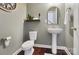 Modern powder room with pedestal sink and wood floor at 501 Alucio Ct, Matthews, NC 28104