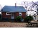 Brick house with backyard, picnic table, and central AC units at 518 Oak St, Troy, NC 27371