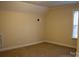 Bright bedroom with neutral walls, carpet, and window at 518 Oak St, Troy, NC 27371